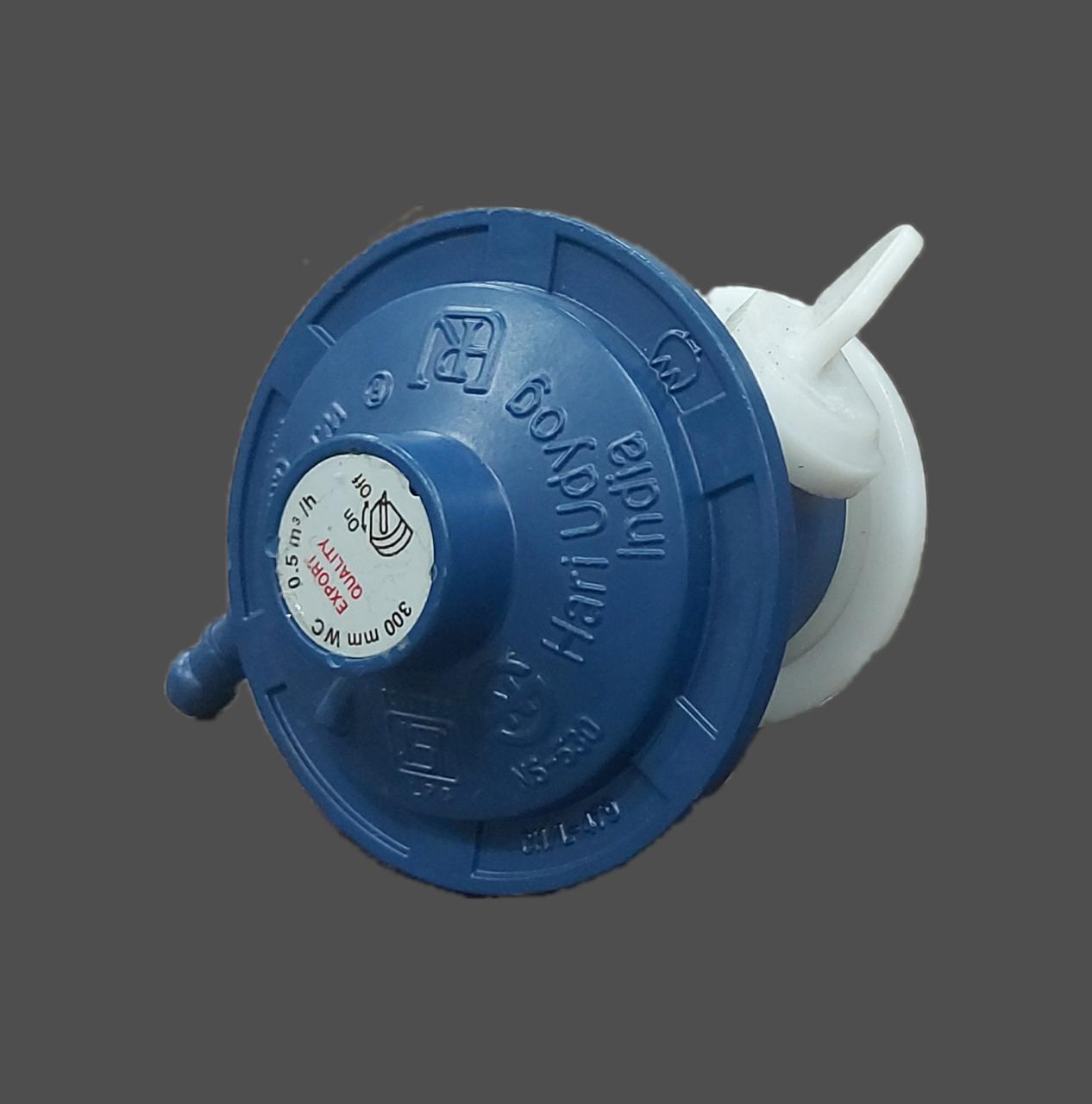 Angled view of a blue LPG regulator and its branded control knob